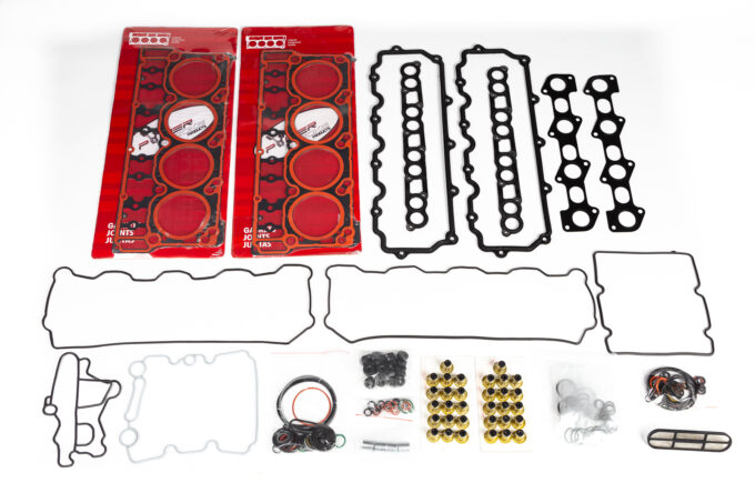 "High-quality head gaskets and cylinder heads for performance engine products, including turbo upgrades and diesel engine rebuild kits, showcased alongside Powerstroke parts in a well-lit workshop setting."
