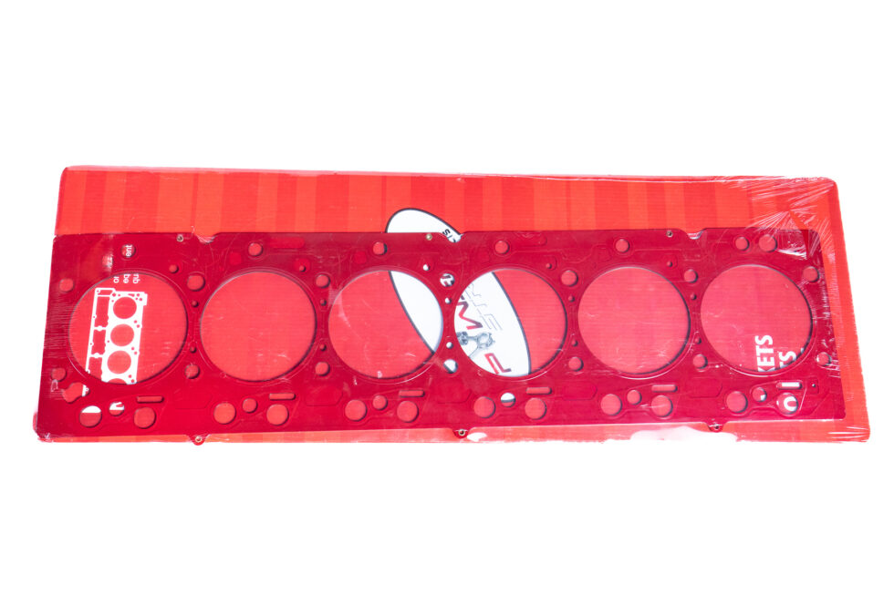 "Close-up image of high-performance head gaskets and cylinder heads, showcasing premium performance engine products for turbo upgrades and diesel engine rebuild kits, including top-quality Powerstroke parts."