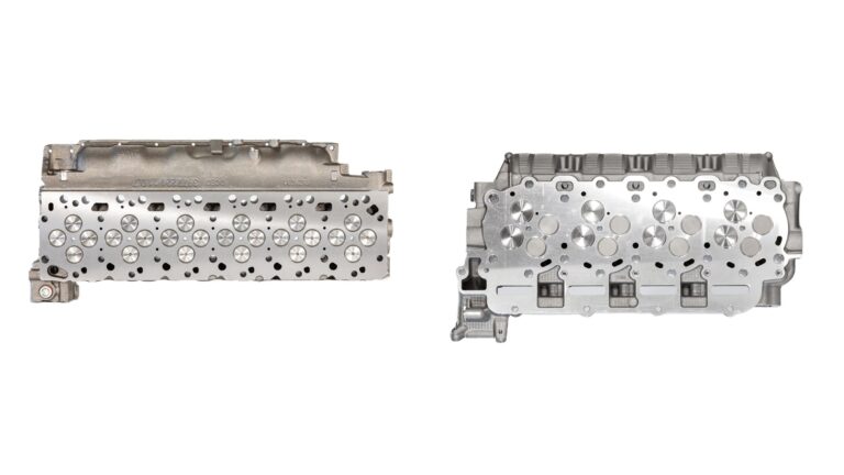 6.7 Cummins cylinder head beside a 6.7 Powerstroke cylinder head