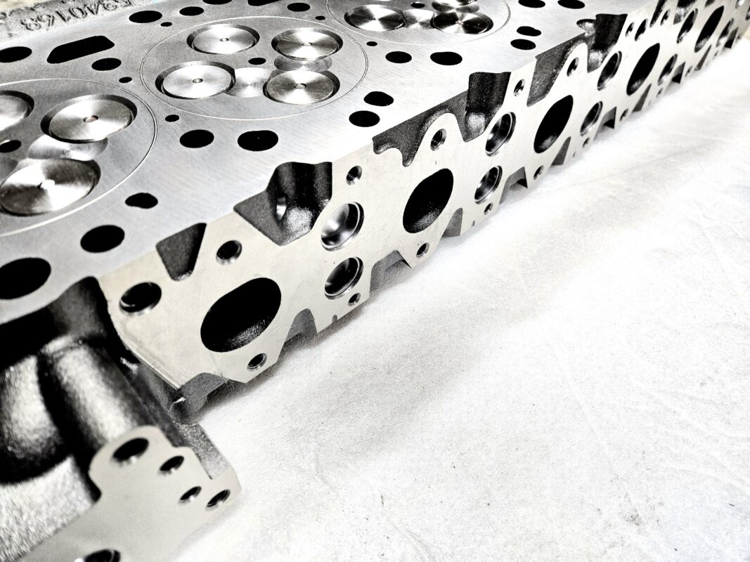 "Close-up view of high-quality head gaskets and cylinder heads for performance engine products, including turbo upgrades and diesel engine rebuild kits, specifically designed for Powerstroke parts."
