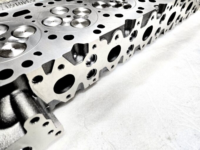 "Close-up view of high-quality head gaskets and cylinder heads for performance engine products, including turbo upgrades and diesel engine rebuild kits, specifically designed for Powerstroke parts."