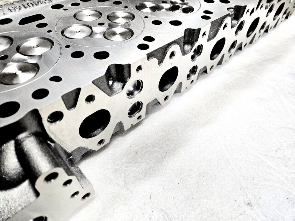"Close-up view of high-quality head gaskets and cylinder heads for performance engine products, including turbo upgrades and diesel engine rebuild kits, specifically designed for Powerstroke parts."